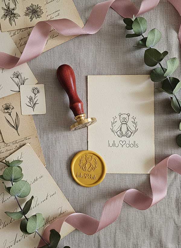 Kolekcjonerski stempel do laku okrągły 40 mm, złote odbicie logo Lulu Dolls, mosiężny, idealny do brandingu produktów premium.